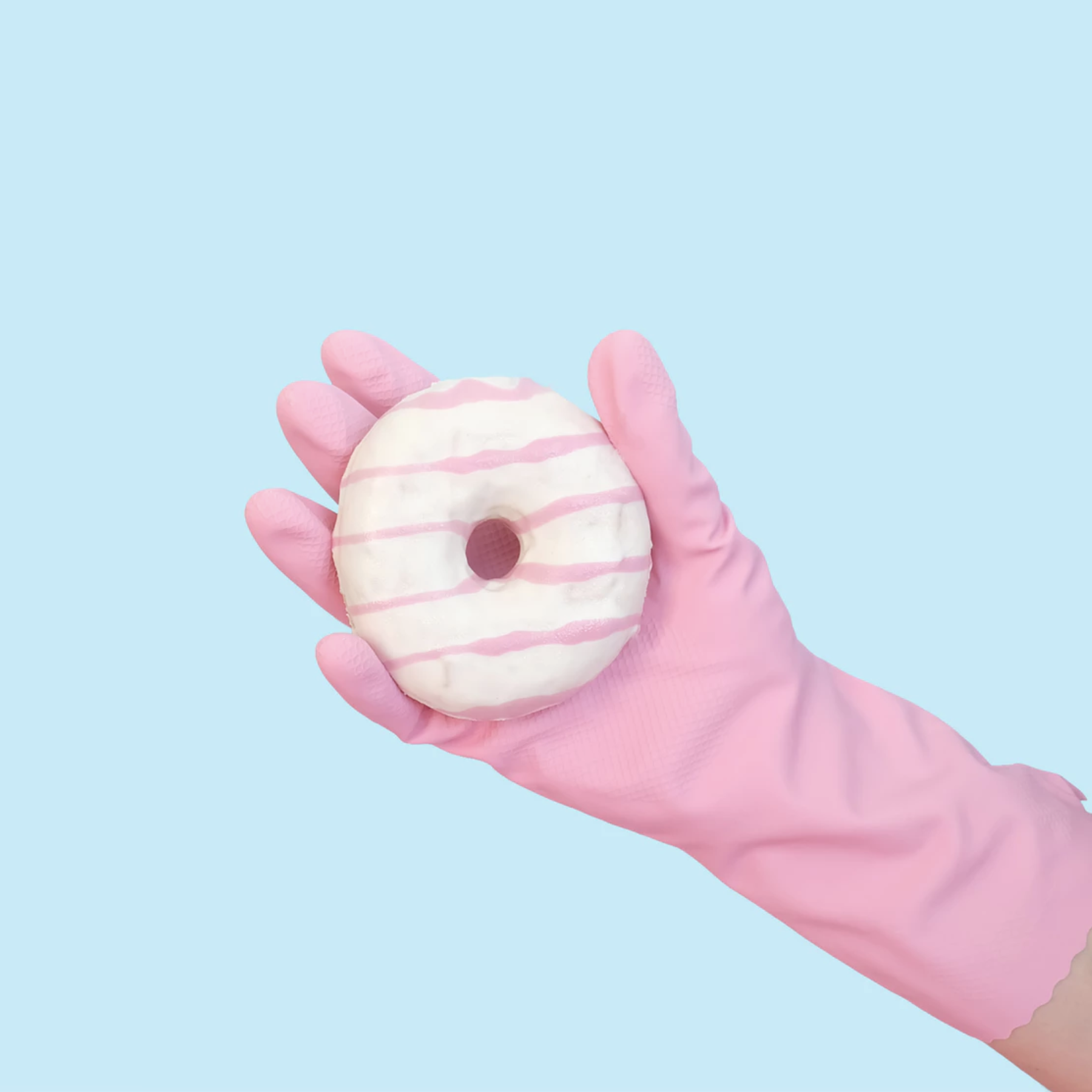 Gloved hand holding a dounut